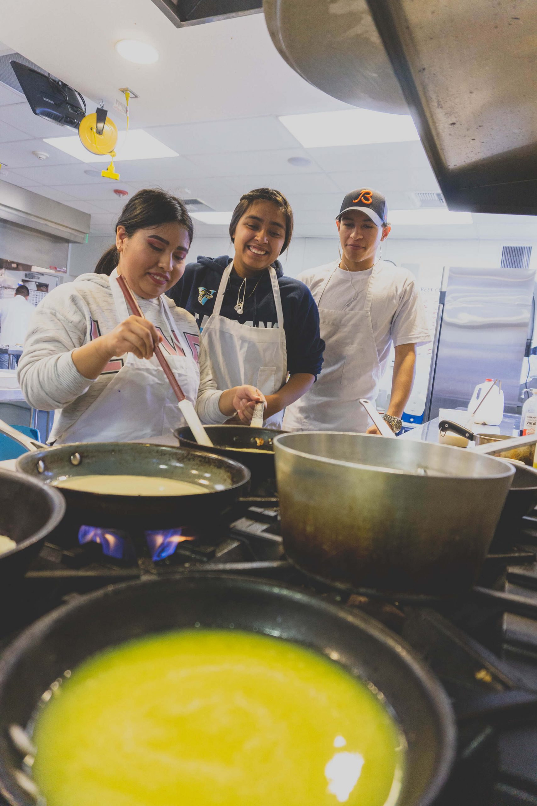 Chefs in training cook up a reduction recipe for culinary arts.